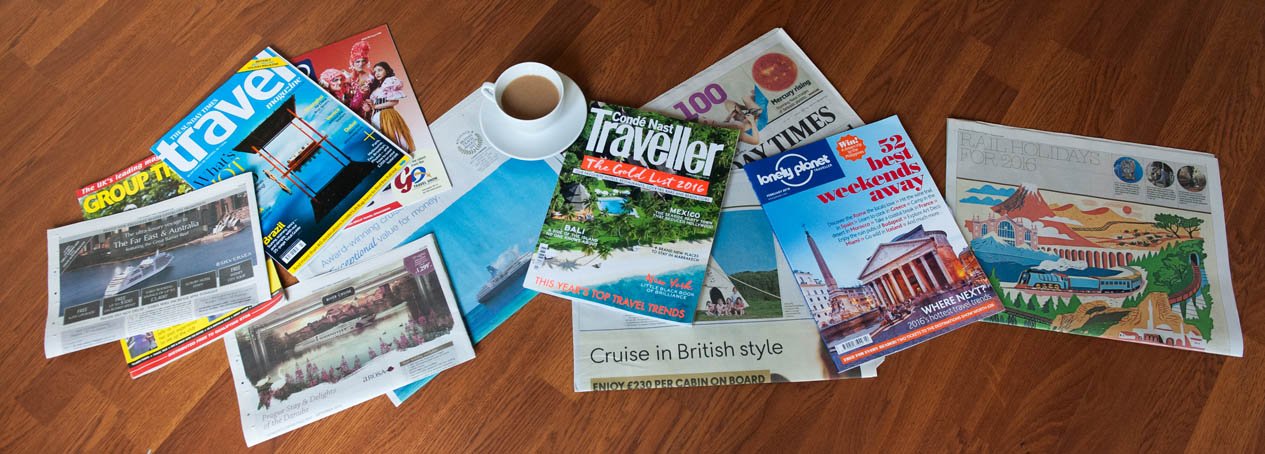 Travel magazines spread out on a table